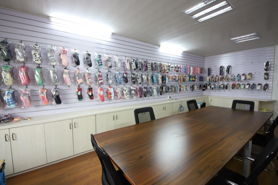Sample room with a wall of sock samples and a meeting table